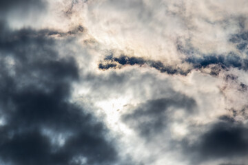 Dark storm clouds with sunlight behind