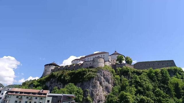Timelapse of Kufstein fortress overlooking scenic sky and clouds in Austria bringing historical charm to life