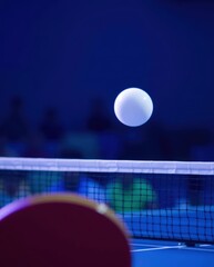 Exciting battle of skill as a ping pong ball hovers over the net during an intense table tennis match in a vibrant arena