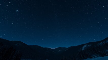 Fototapeta premium A breathtaking night sky filled with countless stars shines brilliantly over a dark mountain range silhouette.