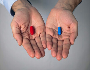 Businessman choosing between two pills, red or blue one