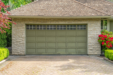 Garage door in luxury house with trees and nice landscape in Spring in Vancouver, Canada, North...
