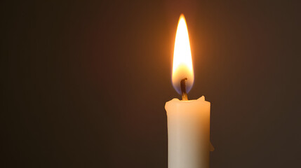 A single, dripping candle with a warm, yellow flame.
