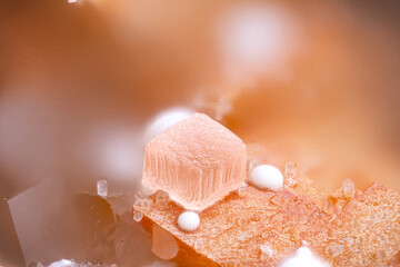 rhombohedral clear Smithsonite on orange Siderite with white Hydrozincite ball. Specimen from La...