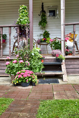 Front view of a summer porch decorated with bright summer flowers
