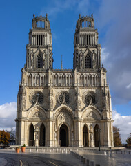 Orleans Cathedral in France, a Gothic-style church with two towering spires and an ornate facade. The cathedral stone carvings and large stained-glass windows was visited frequently by Joan of Arc.