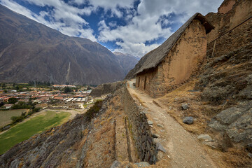 Majestic view of the Ollantaytambo archaeological site in Cusco, Peru. Massive stone terraces rise...
