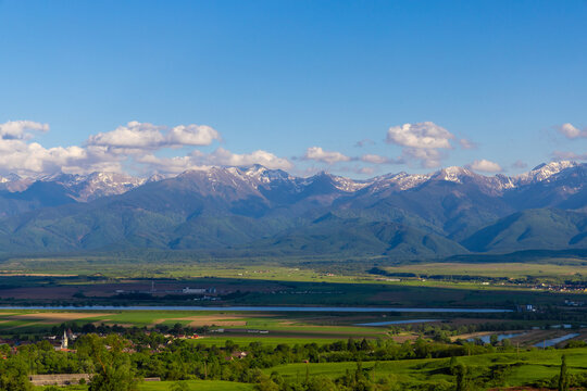 Landscape with a village in the foreground and the Fagaras Mountains in the background