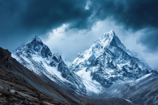Snow-capped mountains under a dramatic stormy sky