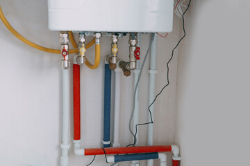 Installation of a gas boiler with colored pipes equipped with valves and connectors for efficient...