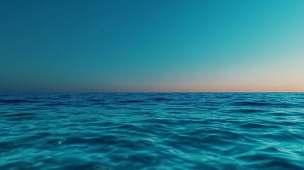 Obraz premium Panoramic view of the tranquil ocean under a gradient blue and orange sky