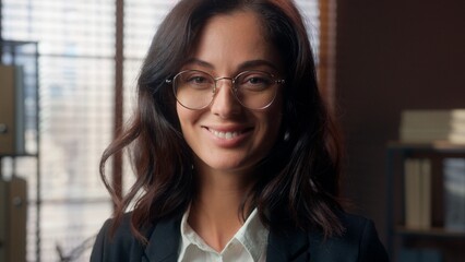 Fototapeta premium Cheerful Caucasian woman wear glasses vision health eyes female girl businesswoman business office indoor looking at camera optic smiling employee manager eyeglasses happy entrepreneur eyesight pose