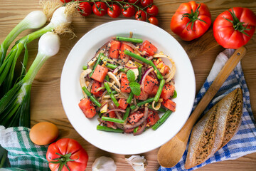 Summer salad with watermelon, fennel and green beans. Top view table with christmas decorations.