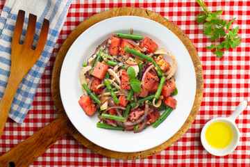 Summer salad with watermelon, fennel and green beans. Top view table with christmas decorations.