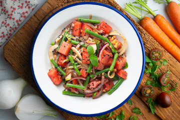 Summer salad with watermelon, fennel and green beans. Top view table with christmas decorations.