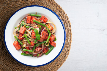 Summer salad with watermelon, fennel and green beans. Top view table with christmas decorations.