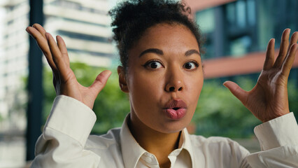 Shocked African American woman female girl businesswoman brainstorm headshot outdoors face brain head boom gesture problem overwhelmed mind expression emotions business city explosion bomb ethnic town