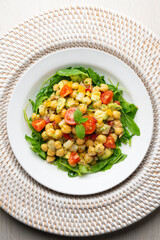 Mediterranean chickpea salad with avocados and vegetables. Top view table with christmas decorations.