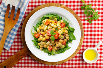 Mediterranean chickpea salad with avocados and vegetables. Top view table with christmas decorations.
