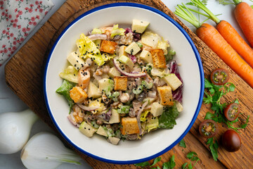 Waldorf salad with apple, raisins, walnuts, and mayonnaise dressing. Top view table with christmas...