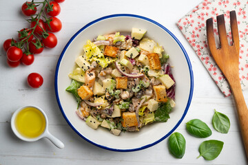 Waldorf salad with apple, raisins, walnuts, and mayonnaise dressing. Top view table with christmas decorations.