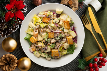 Waldorf salad with apple, raisins, walnuts, and mayonnaise dressing. Top view table with christmas decorations.