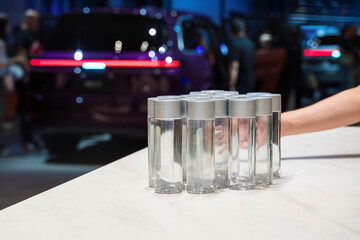 Attendees at the car show stay hydrated with complimentary water bottles on display at the event