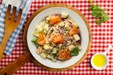 Waldorf salad with delicious smoked salmon, apple, raisins, walnuts, and mayonnaise dressing.