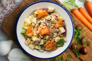 Waldorf salad with delicious smoked salmon, apple, raisins, walnuts, and mayonnaise dressing.