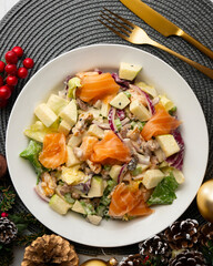 Waldorf salad with delicious smoked salmon, apple, raisins, walnuts, and mayonnaise dressing.