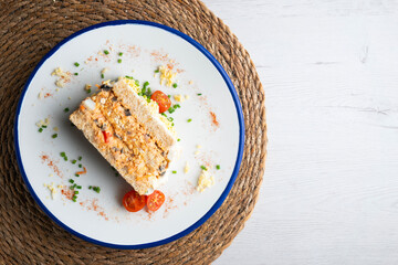 Cold tuna pie with vegetables and sliced ​​bread.  Top view table with christmas decorations.