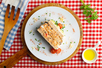 Cold tuna pie with vegetables and sliced ​​bread.  Top view table with christmas decorations.