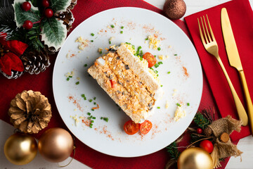 Cold tuna pie with vegetables and sliced ​​bread.  Top view table with christmas decorations.