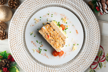 Cold tuna pie with vegetables and sliced ​​bread.  Top view table with christmas decorations.
