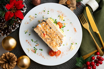 Cold tuna pie with vegetables and sliced ​​bread.  Top view table with christmas decorations.