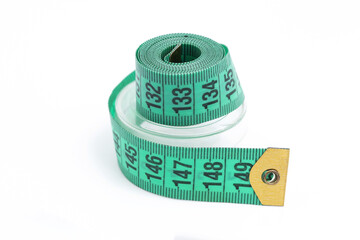 Green tailor tape roll. Measuring tool for sewing. Flexible centimeter strip. Accurate measurement...