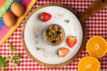 Greek yogurt with strawberries and granola made with cereals and nuts. Top view table with christmas decorations.