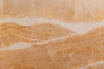 Polished marble stone surface with natural beige and white pattern, smooth texture and elegant