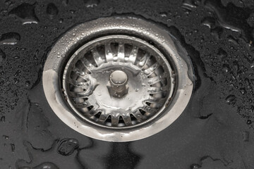 Close up of a stainless steel sink drain