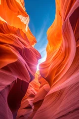 Fototapete Spectacular view of antelope canyon's orange and red rock formations under a bright blue sky © ImageHome
