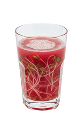 Fresh red drink with delicate sprouts floating within the glass, against a dark background