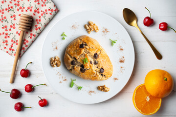 Triangular English scones with dark chocolate chips. Top view table with christmas decorations.