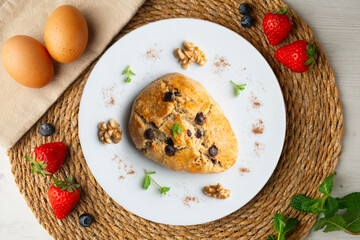 Triangular English scones with dark chocolate chips. Top view table with christmas decorations.