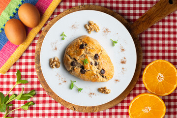 Triangular English scones with dark chocolate chips. Top view table with christmas decorations.