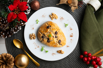 Triangular English scones with dark chocolate chips. Top view table with christmas decorations.