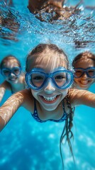 Fototapeta premium Three joyful children submerged in a pool, wearing goggles, enjoying the water. A fun summer vibe filled with laughter and happiness.