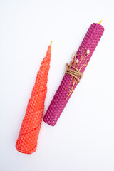 DIY wax candle making process. Woman making decorative wax candle and decorates with dried flowers, close-up of hands