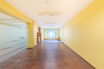 Modern Empty Office Space with Yellow Walls and Wooden Flooring