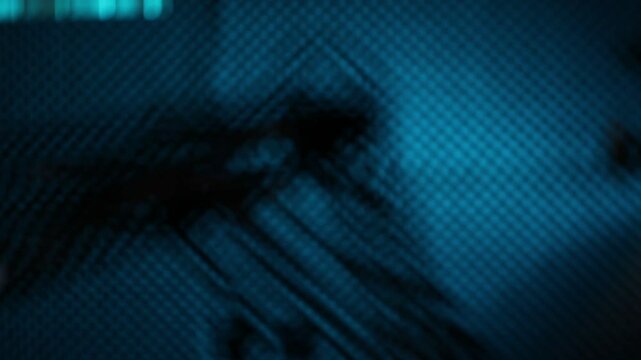  Blurry, abstract close-up of a 3D printer nozzle or mechanical arm moving. Dimly lit with a textured blue background, creating a mysterious, technological feel.