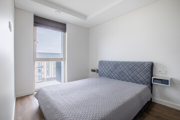 Fototapeta premium Minimalistic Modern Bedroom Interior With Window and Cozy Bed Setting